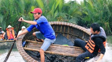 Tourists enjoying a fun basket boat ride at Hoi An Coconut Village, Vietnam — a must-try local experience in Vietnam family and honeymoon tours.